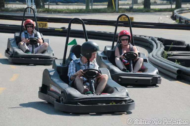 three people racing in gocarts