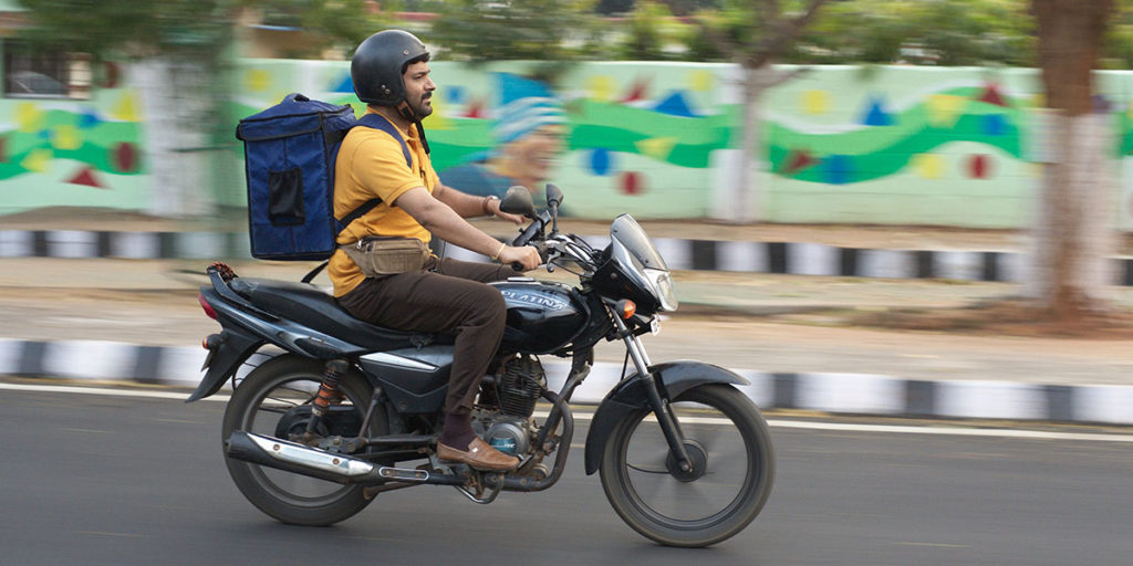 Still from the film Zwigato showing a food delivery driver on a motorbike