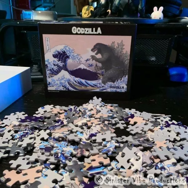 Godzilla jigsaw puzzle pieces on a table