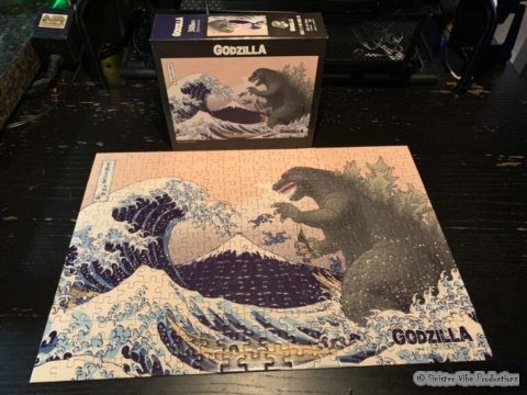 Godzilla jigsaw puzzle pieces on a table