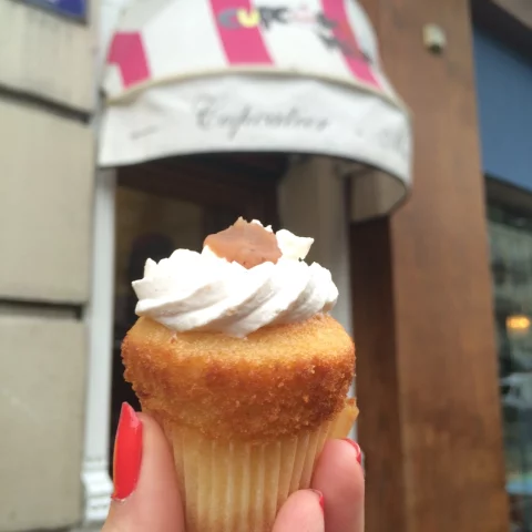 hand holding a small French cupcake