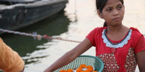 photo of little girl holding a basket of marigolds