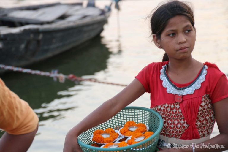 photo of little girl holding a basket of marigolds