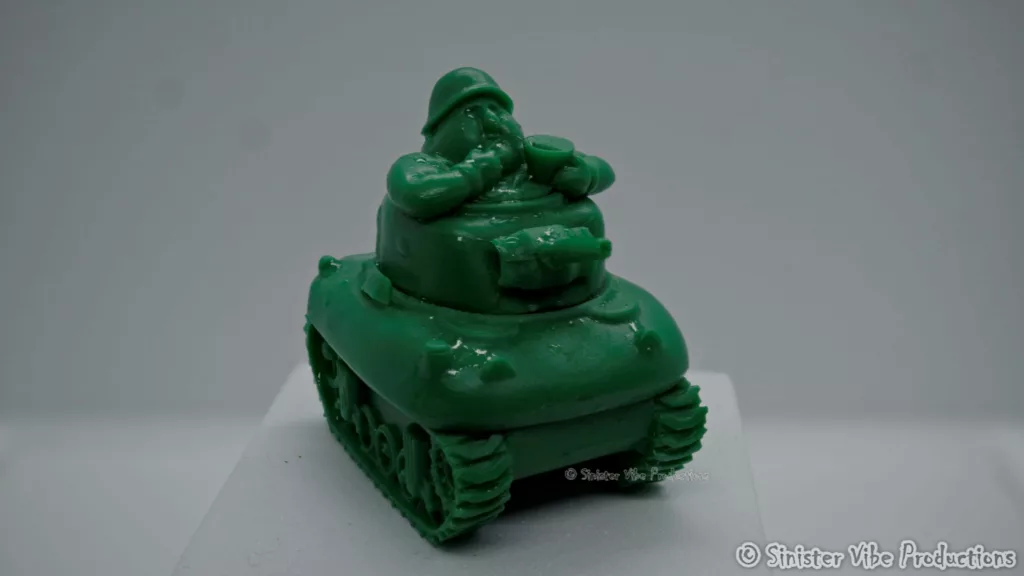 photo of small fat green army man stuck in tank with popcorn bucket