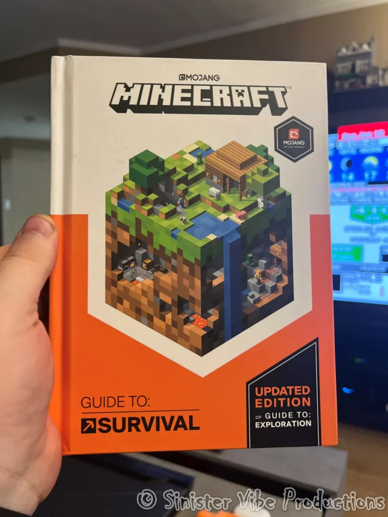 Photo of hand holding a Minecraft book