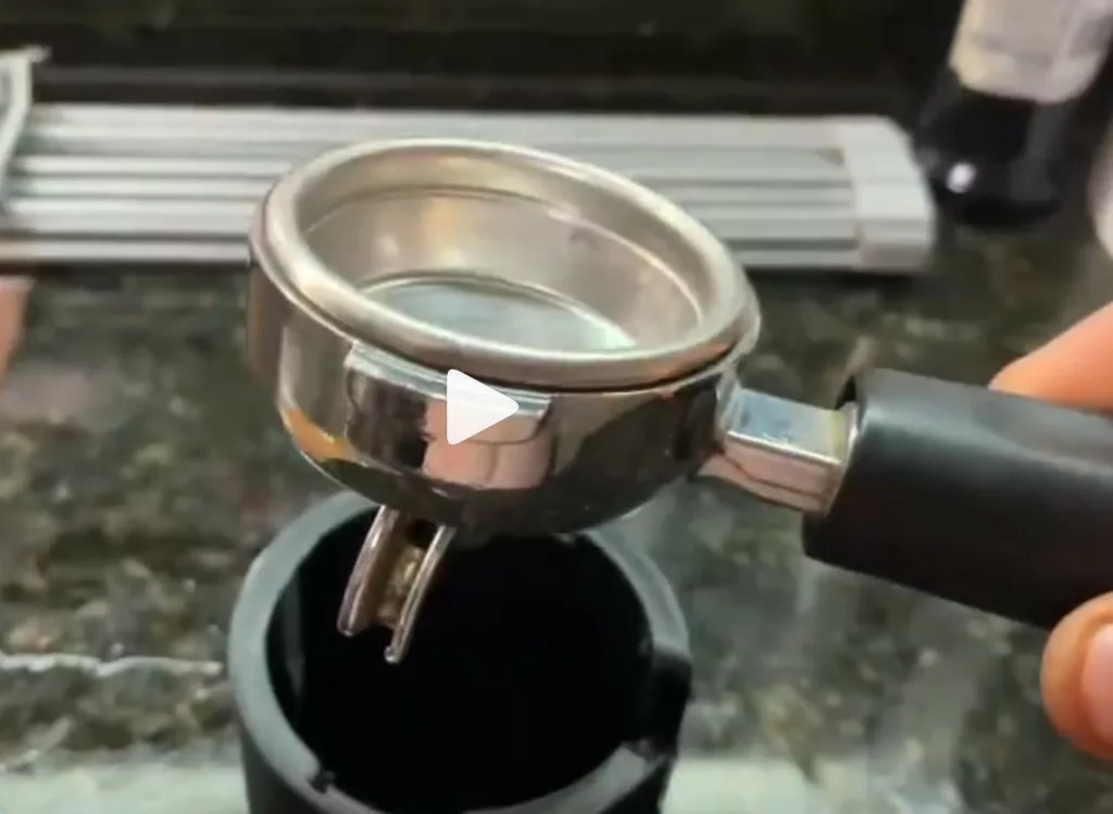 Hand holding an espresso portafilter