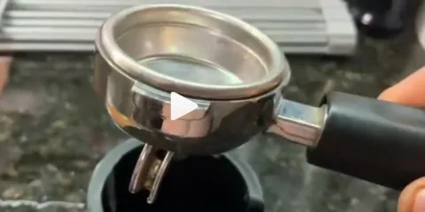 Hand holding an espresso portafilter