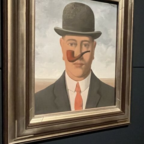 Photo of painting of man win bowler hat and pipe