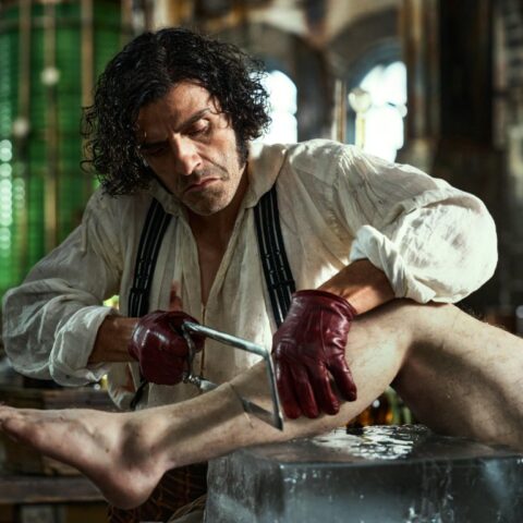 Photo of Dr. Frankenstein cutting a a cadaver lag